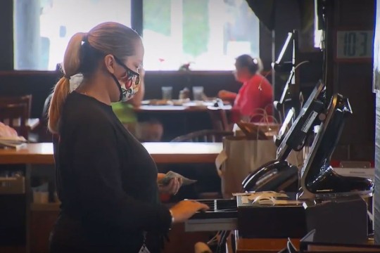 person opening a till in a restaurant.