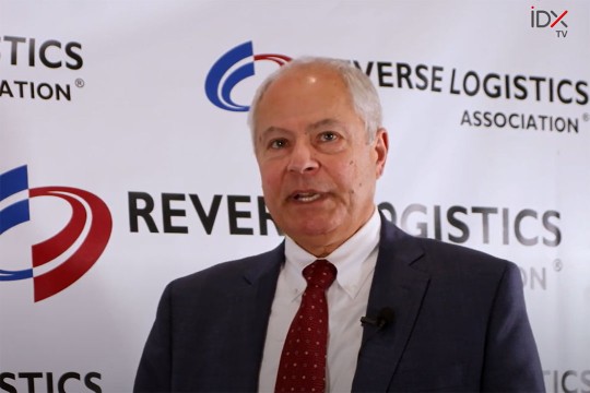 screenshot of person talking in front of a backdrop for the Reverse Logistics Association.