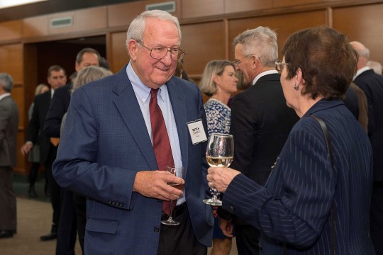 two people talking at a reception.
