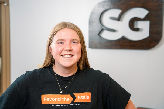 female college student standing in front of an S G sign.