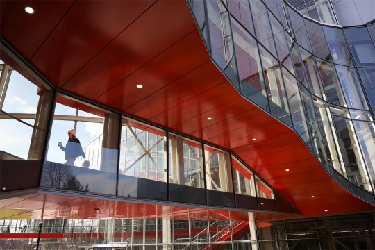 the underneath of an exterior bridge for a glass building. 