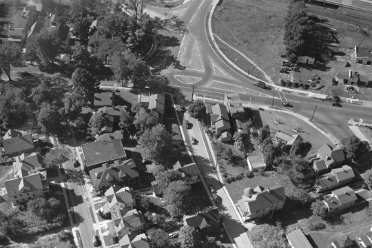 black and white aerial view of a city neighborhood.