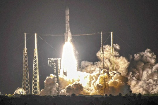a spaceship launching into space, with large plumes of smoke and flames billowing from the thrusters.