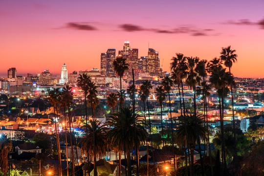Los Angeles skyline is shown in early evening