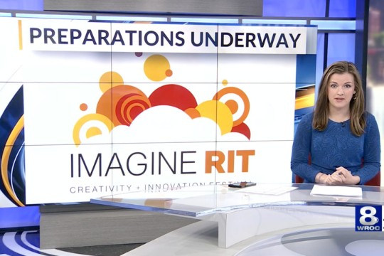 'the Imagine R I T logo is displayed behind a news anchor on News 8 W R O C.'