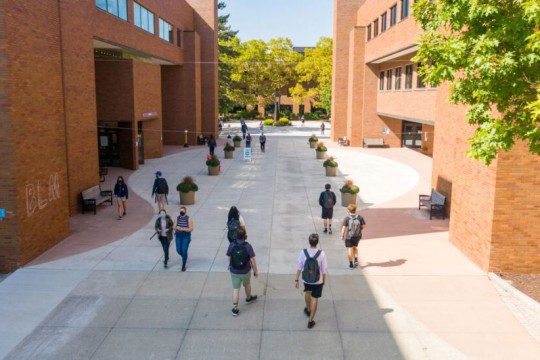 an arial image from a drone captures students walking between buildings in their way to class.