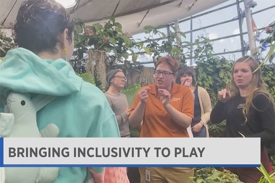 Students from NTID are seen in the butterfly exhibit at The Strong Museum of Play.