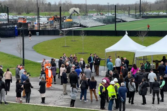 groups of people are seen gathering for the groundbreaking of the new Tigers stadium on the RIT campus.