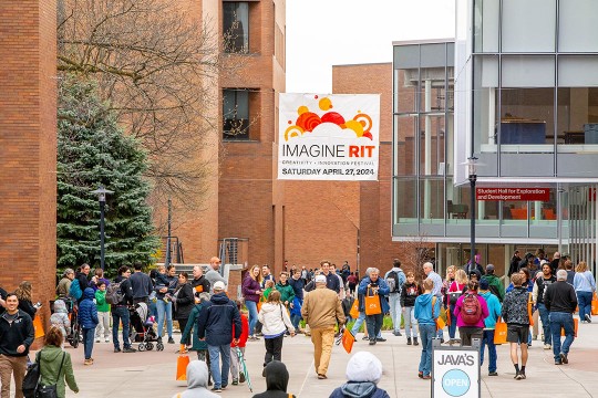 'crowd of people walking along the quarter mile during Imagine RIT'