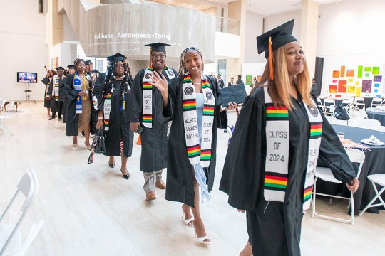 raduates make their way in to the fifth annual Black graduation ceremony