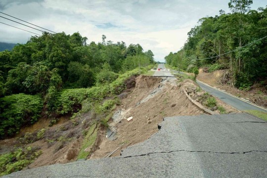 'a road is shown after being taken out by a landslide.'