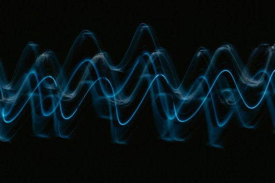 'a soundwave is shown in blue on a black background.'
