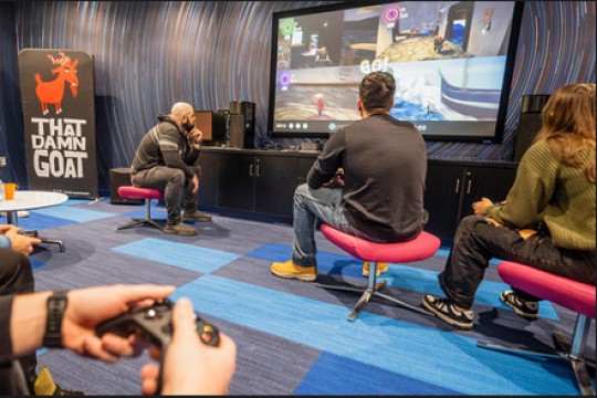 'students are shown in a room playing a video game.'