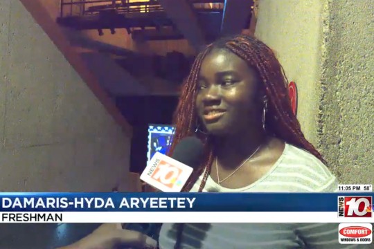 a black female student in a gray and white striped shirt talks to News 10 WHEC. A Chryon with her name appears along the bottom of the screen.