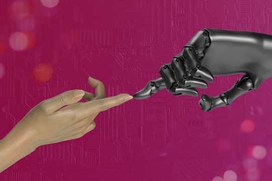 a human hand and a robot hand touch each other in front of a pink background