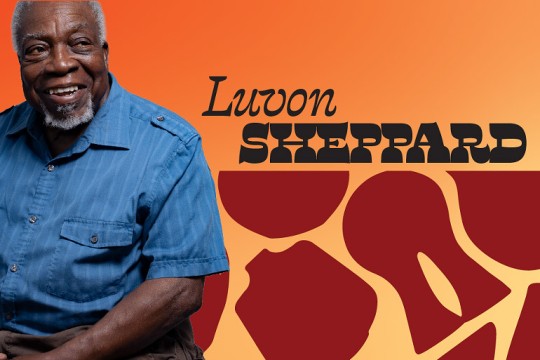 a male sits to the left on an image with an orange background where his name shows to the right.