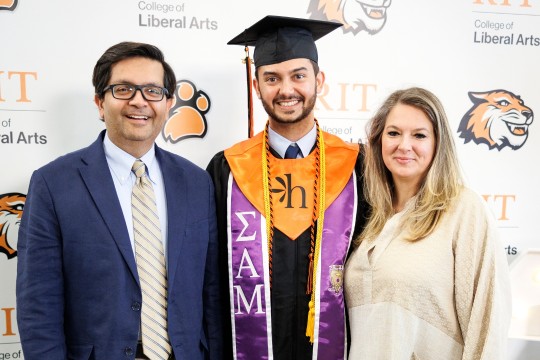 Afnaan poses with his family for a quick photo before commencement. 