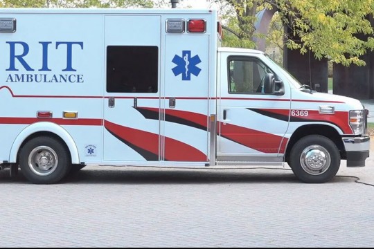 an R I T ambulance is shown in a parking area at R I T.
