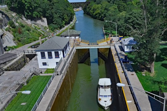 an arial view of a boat at a lock of the erie canal.