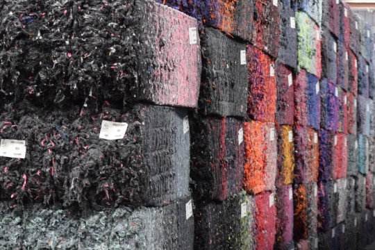 Colorful recycled fiber bales reflect the vibrant textiles they formerly were