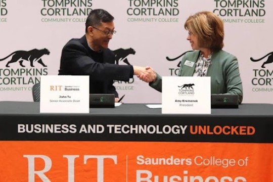 John Tu and Amy Kremenek shaking hands