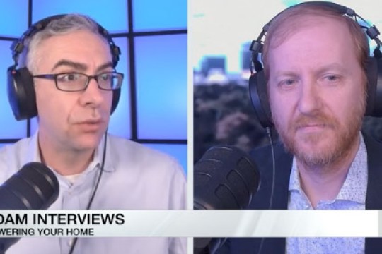 Two men are shown on a split screen T V interview