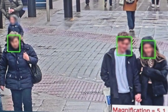 computer screen showing a street scene with green rectangles outlining people's faces