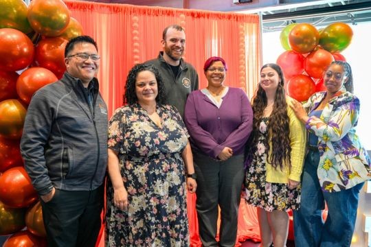 a group of staff pose for a photo during the recognition event