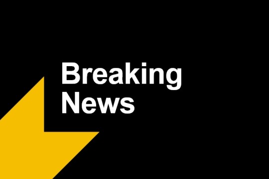 breaking news is written in white with a yellow arrow on the bottom left.
