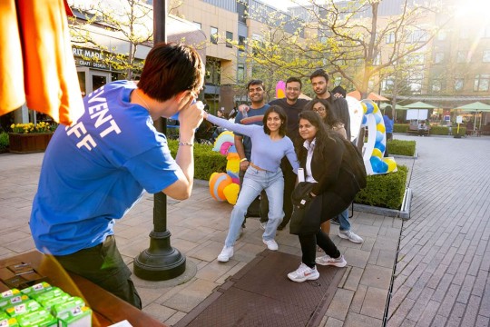 'a group of students smile while getting their photo taken'