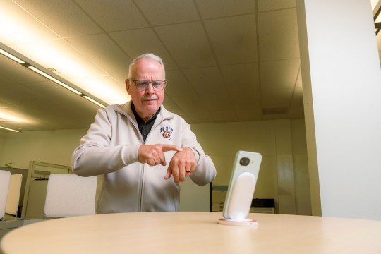 'Gary Behm, director of the NTID Center on Access Technology, uses Google’s Sign Language-to-Text app, which he and others in the center helped evaluate prior to its release. '
