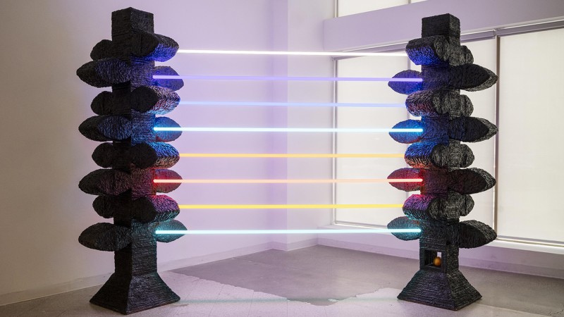 Colorful LED beams connected to ceramic structures.