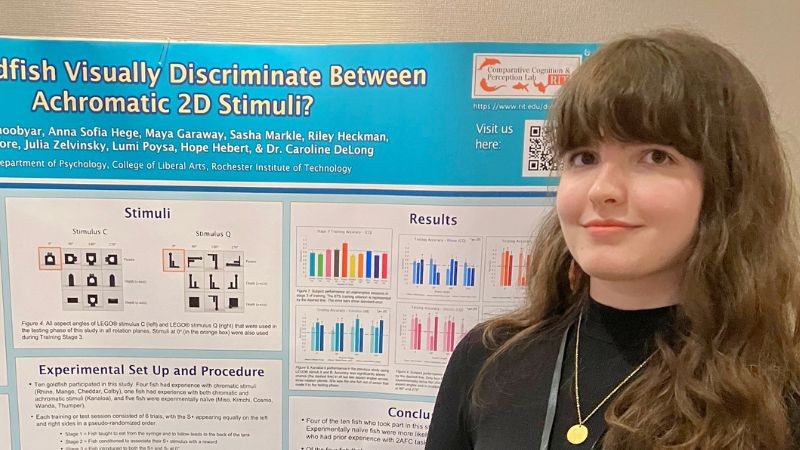 Rose K in front of her research presentation poster
