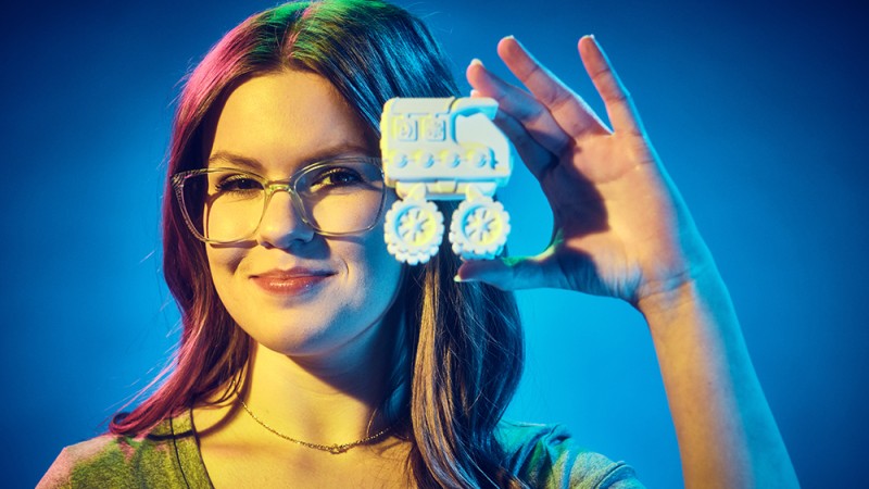 Ava Guarino holds up a 3D-printed toy truck.