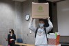 student with box on head