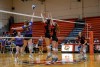 volleyball teams playing close to the net.