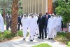 Dubai and RIT officials walking outdoors.
