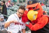 person posing with Red Wings mascot.