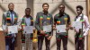 five Black college students wearing Black grads regalia and holding up certificates.
