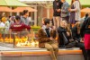 two college students sitting on the edge of a large fire pit.