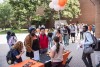 college students lined up outside to go to a table handing out free stuff.