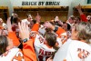 Women's hockey teammates celebrate in a lockerroom