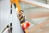 a college age male looks over a balcony on to the main floor of the career fair