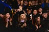 Graduates listen to a speaker.