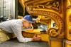 two men connect the pedal assembly to the console of a Barton Opus theater organ