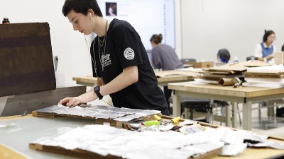 A student works on a wearable sculpture piece for the Charrette event.