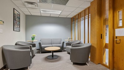 a reception area with soft seating and a small round coffee table.