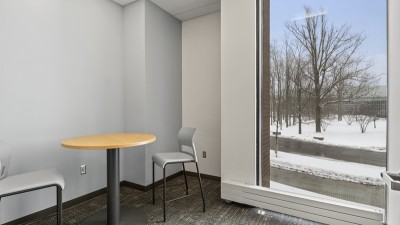 a small meeting room, with a table and two chairs.
