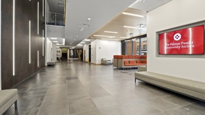 an atrium with a tiled floor and long benches.