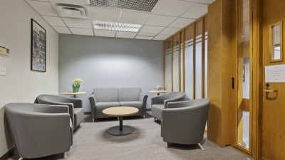 a small waiting room with soft seating and a small round coffee table.